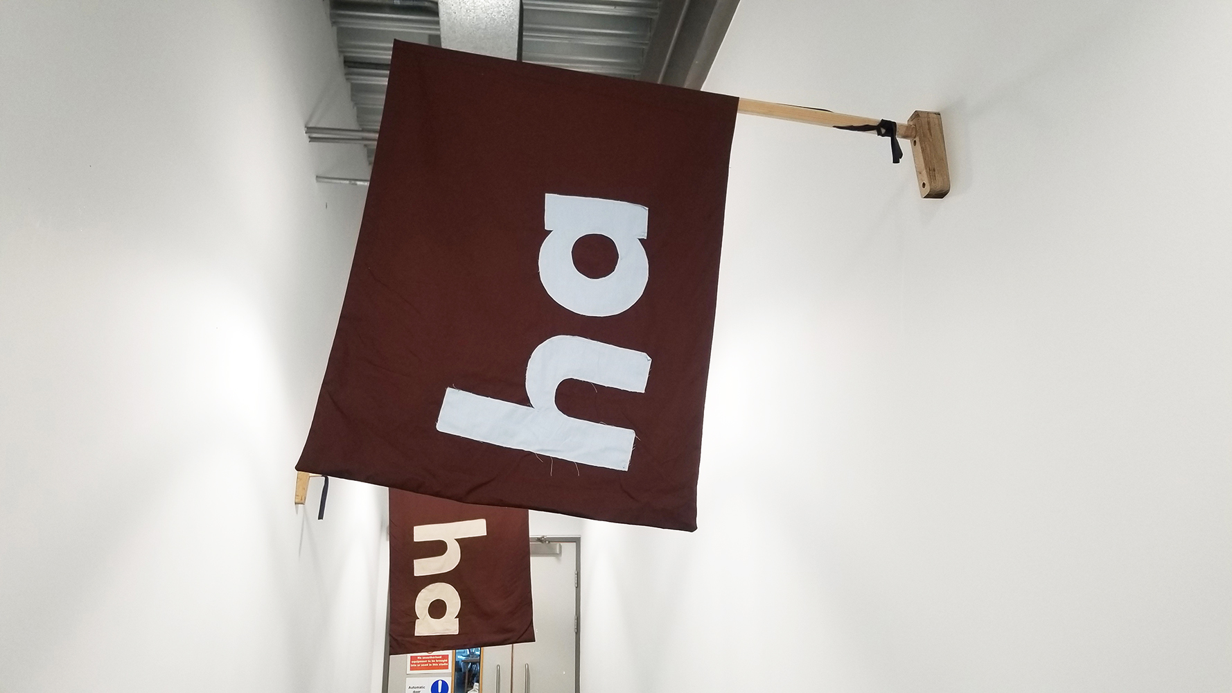 Image of two 'ha ha' flags on the Belfast Telegraph building - clearly displaying 'ha ha'.